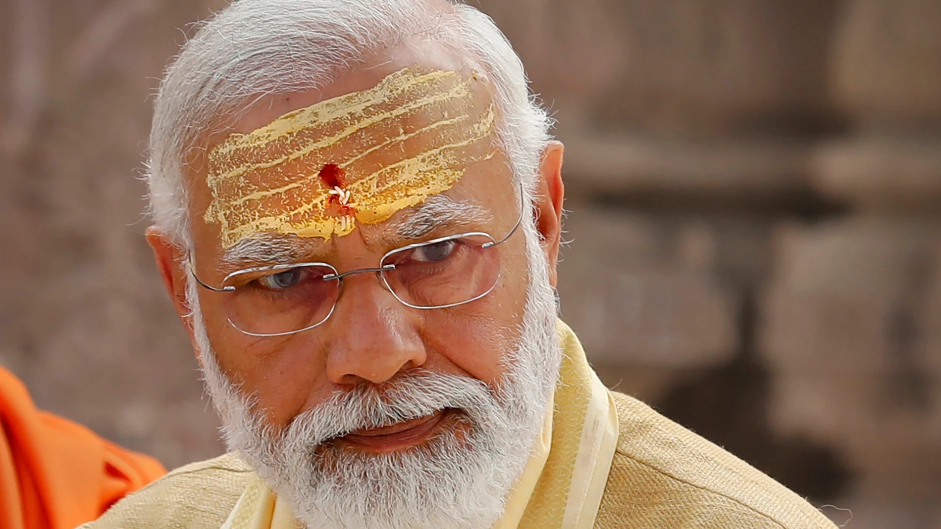 FILE- Indian Prime Minister Narendra Modi has sandalwood paste and vermilion applied on his forehead during the inauguration of Kashi Vishwanath Dham Corridor, a promenade that connects the Ganges River with the centuries-old temple dedicated to Hindu god Shiva in Varanasi, India, Dec. 13, 2021. Hindu nationalism, once a fringe ideology in India, is now mainstream. Nobody has done more to advance this cause than Modi, one of India’s most beloved and polarizing political leaders. (AP Photo/Raj...
