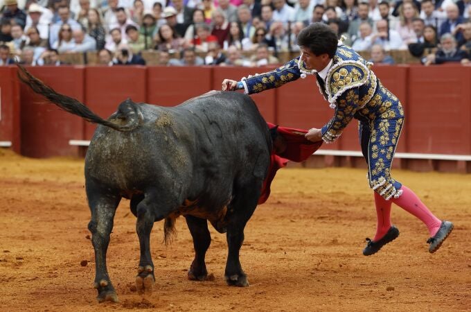 El diestro Esaú Fernández lidia el tercero de la tarde en el último festejo de la Feria de Abril, hoy domingo en la Real Maestranza de Sevilla, con toros de Miura.