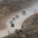 Israeli soldiers maneuver at the border with the Gaza Strip
