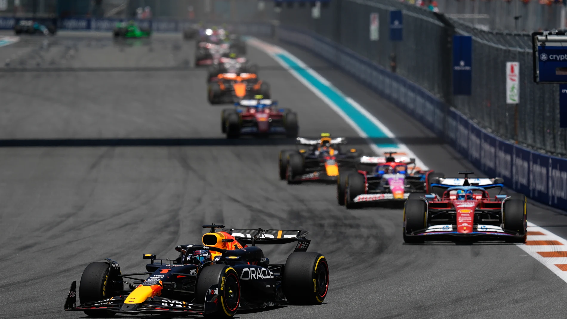 Red Bull driver Max Verstappen of the Netherlands, front, leads the pack followed by Ferrari driver Charles Leclerc of Monaco, right, during the Sprint race at the Formula One Miami Grand Prix auto race, Saturday, May 4, 2024, in Miami Gardens, Fla. (AP Photo/Rebecca Blackwell)