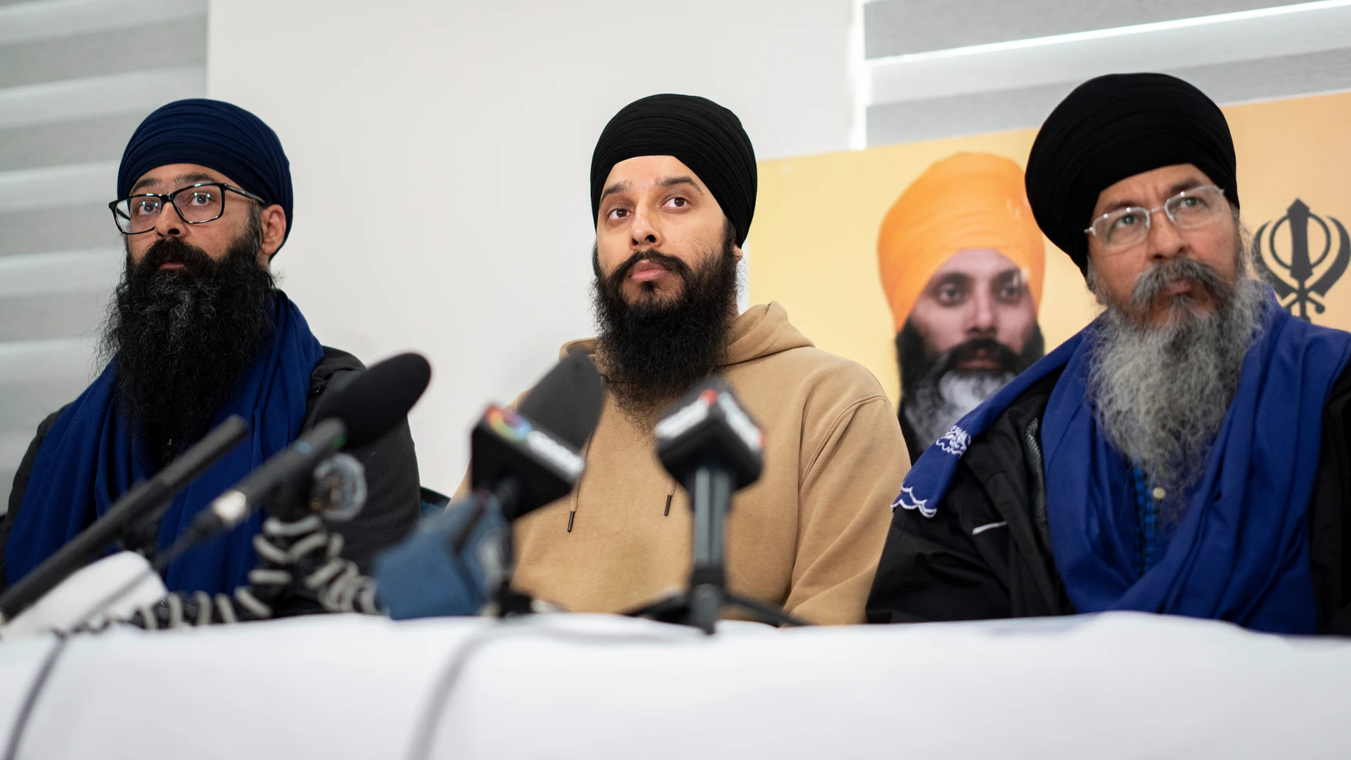 From Left to right, Moninder Singh, Brabjot Singh, and Gurmeet Singh, listen to media questions during a news conference providing an update from the executive members and committee of the Guru Nanak Sikh Gurdwara about the Hardeep Singh Nijjar homicide from June 18, 2023 in Surrey, B.C. on Friday, May 3, 2024. (Ethan Cairns/The Canadian Press via AP)