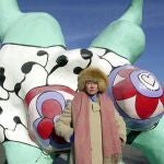 French-born artist Niki de Saint Phalle posing in front of her `Nana`sculptures on display in Hanover