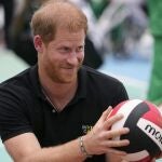 Prince Harry, holds a volley ball during an exhibition sitting volleyball match in Abuja, Nigeria