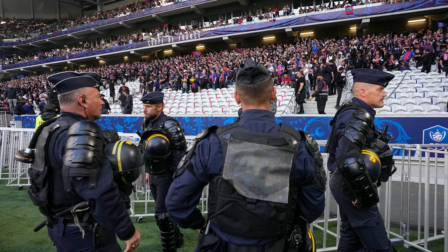 French riot police officers stand on the side of the pitch before the French Cup final soccer match between Lyon and PSG at the Pierre Mauroy stadium in Villeneuve d'Ascq, northern France, Saturday, May 25, 2024. (AP Photo/Michel Euler)