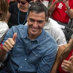 Spain's Prime Minister Pedro Sanchez next to his wife Begona Gomez, gives a thumb up during a campaign closing meeting in Madrid, Spain.