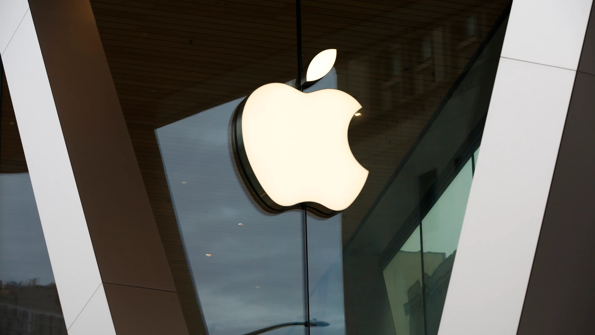 FILE - An Apple logo adorns the facade of the downtown Brooklyn Apple store on March 14, 2020, in New York. Apple Inc. plans to add several new features to Apple Pay and Apple Wallet later this year that will more deeply integrate financing, rewards, and buy now, pay later options into the iPhone when consumers shop on their phones. (AP Photo/Kathy Willens, File)