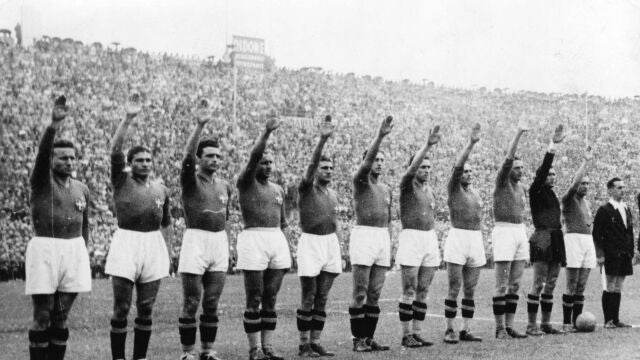 The Italian soccer team perform the fascist salute in Colombes Stadium, Paris, before the start of the World Cup final soccer match against Hungary on June 19, 1938. Earlier in the tournament that was taking place amid the drumbeat of war, the team caused consternation by wearing black shirts in a match. 