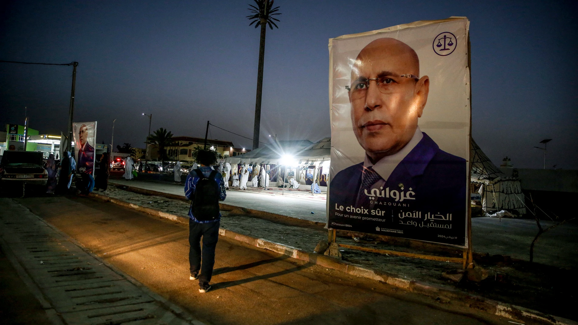 An electoral banner for Mauritanian president Mohamed Ould Ghazouani is placed during a campaign rally, ahead of the presidential elections in Nouakchott, Mauritania, Wednesday, June 26, 2024. Banner in Arabic reads: "Safe choice." (AP Photo/Mamsy Elkeihel)