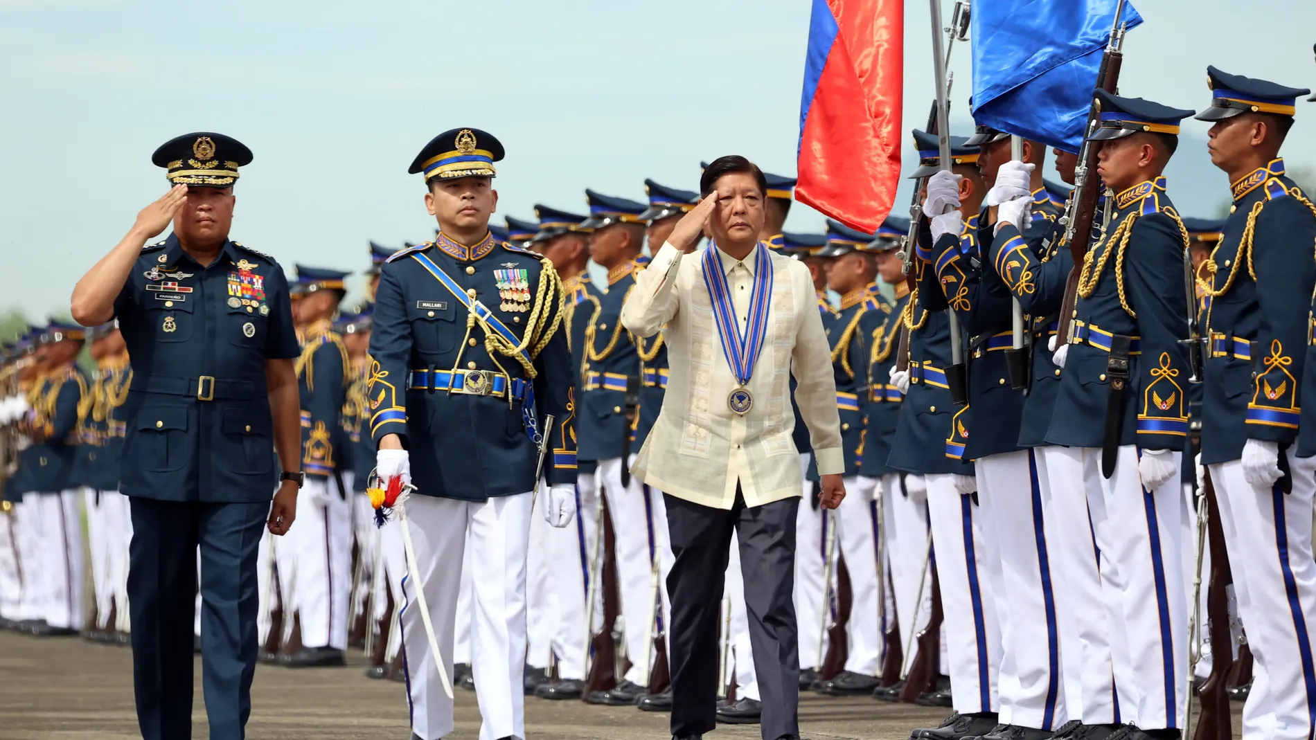 Floridablanca (Philippines), 01/07/2024.- Philippine President Ferdinand 'Bongbong' Marcos Junior (C) and Air Force chief General Stephen Parreno (L) review honor guards during the 77th anniversary of the Philippine Air Force (PAF) at Basa Air Base in the town of Floridablanca, Pampanga province, Philippines, 01 July 2024. (Filipinas) EFE/EPA/KJ ROSALES / POOL