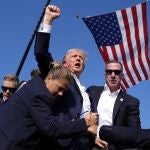 Republican presidential candidate former President Donald Trump is surrounded by U.S. Secret Service agents at a campaign rally, Saturday, July 13, 2024, in Butler, Pa. (AP Photo/Evan Vucci)