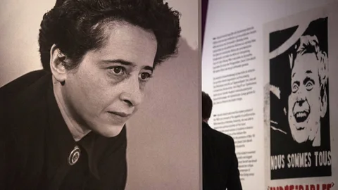 A photograph of German-American philosopher and political theorist Hannah Arendt (L) and a poster featuring a likeness of May 68 student leader Daniel Cohn- Bendit are on display during a press preview of the exhibition "Hannah Arendt and the Twentieth Century" at the German Historical Museum (Deutsches Historisches Museum - DHM) in Berlin