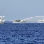 Un buque filipino, en el centro, es alcanzado por cañones de agua de dos barcos guardacostas chinos cuando intentaba llegar al disputado atolón Second Thomas, en el Mar de China Meridional