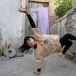 In this photo taken on June 12, 2021, Manizha Talash, the only female member of a group of breakdancers comprised of mostly Hazara boys, practices a move in Kabul. The Taliban outlawed dozens of seemingly innocuous activities and pastimes in Afghanistan during their 1996-2001 rule -- including kite flying, TV soap operas, pigeon racing, fancy haircuts, and even playing music. These have made a comeback in the years since, but fears are growing they will be banned again if the hardline Islamists return to power. (Photo by ADEK BERRY / AFP) / TO GO WITH'AFGHANISTAN-CONFLICT-TALIBAN-LEISURE',FOCUS BY JAY DESHMUKH AND AFP'S AFGHANISTAN TEAM - TO GO WITH'AFGHANISTAN-CONFLICT-TALIBAN-LEISURE',FOCUS by Jay DESHMUKH and AFP's Afghanistan team