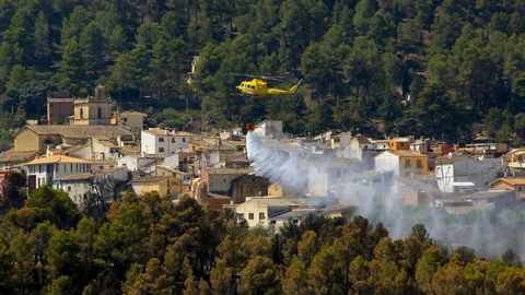 Un helicóptero refresca el perímetro de la localidad de Penáguila