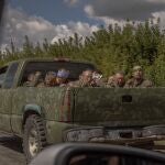 A Ukrainian military vehicle drives from the direction of the border with Russia carrying blindfolded men in Russian military uniforms, in the Sumy region, on August 13, 2024, amid the Russian invasion of Ukraine. - On August 6, 2024, Ukraine launched an offensive surprise into the Russian border region of Kursk capturing over two dozen towns and villages in the most significant cross-border attack on Russian territory since World War II. Ukraine's military chief Oleksandr Syrsky told the Ukrainian President in a video posted on August 12, 2024 that his troops now control about 1,000 square kilometres of Russian territory and are continuing "offensive operations". (Photo by Roman PILIPEY / AFP)