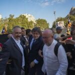 Catalan independence leader and former President Carles Puigdemont, center, arrives to address supporters and to attend the investiture debate near the Catalan parliament in Barcelona, Spain, Thursday Aug. 8, 2024.