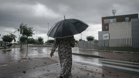 Una mujer camina bajo la lluvia