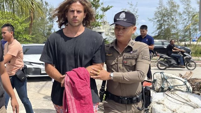 A Thai police officer escorts Spanish Daniel Sancho Bronchalo on suspicion of murdering and dismembering a Colombian surgeon from Koh Phagnan island to Koh Samui Island court