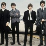 The Beatles, from left, John Lennon, George Harrison, Ringo Starr and Paul McCartney arrive in Liverpool, England on July 10, 1964, for the premiere of their movie "A Hard Day's Night."