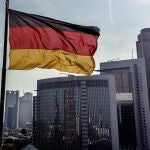 A German flag waves in front of the buildings of the banking district in Frankfurt, Germany, Friday, Aug. 30, 2024. 