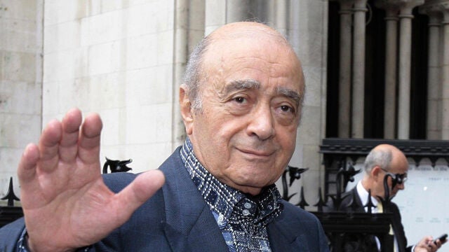 Mohamed al Fayed waves to the media as he arrives at the Royal Courts of Justice in London.