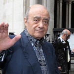 Mohamed al Fayed waves to the media as he arrives at the Royal Courts of Justice in London.