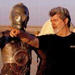 In this undated publicity photo released by Lucasfilm Ltd. & TM, director George Lucas directs actor Anthony Daniels, who plays the robot C-3PO, in "Star Wars II: Attack of the Clones," on location in the Tunisian desert.