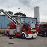 Bomberos de Cantabria retirando la chapa afectada por el viento de una nave. 