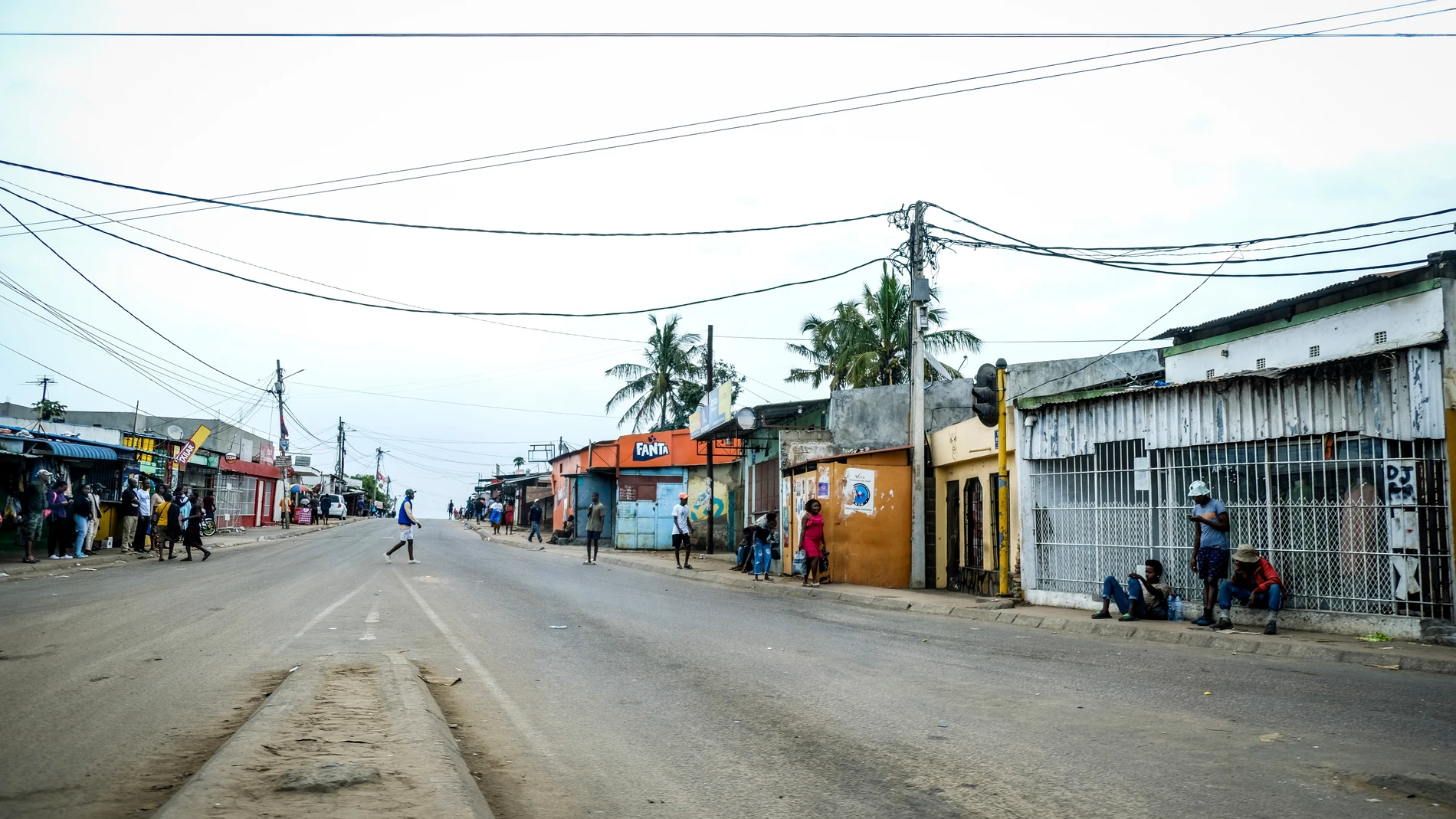 A lone man crosses the empty streets of Maputo, Mozambique, Monday, Oct. 21, 2024, during a nationwide shutdown protest following a disputed Oct. 9 election. (AP Photo/Carlos Uqueio)
