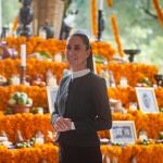 Handout picture released by the Mexican Presidency showing President Claudia Sheinbaum posing in front an altar during the commemoration of the Day of the Dead at the National Palace in Mexico City on November 1, 2024. 