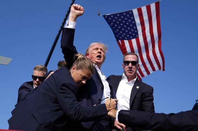 Republican presidential candidate former President Donald Trump is surrounded by U.S. Secret Service agents at a campaign rally, Saturday, July 13, 2024, in Butler, Pa. 