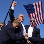 Republican presidential candidate former President Donald Trump is surrounded by U.S. Secret Service agents at a campaign rally, Saturday, July 13, 2024, in Butler, Pa. 