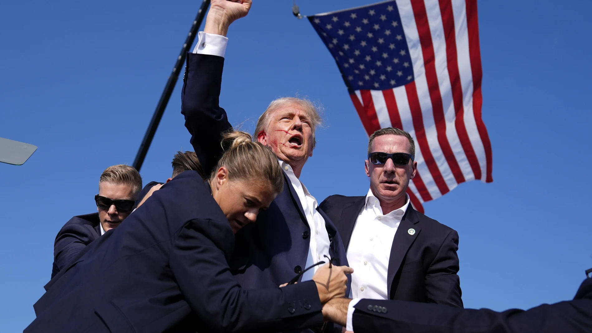 Republican presidential candidate former President Donald Trump is surrounded by U.S. Secret Service agents at a campaign rally, Saturday, July 13, 2024, in Butler, Pa.