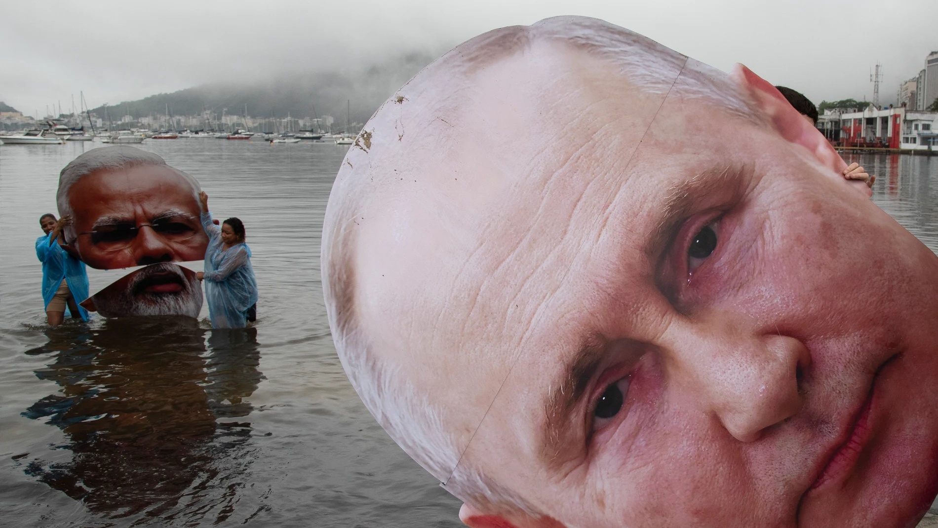 Activists from a Brazilian Indigenous movement hold cutouts of Indian Prime Minister Narendra Modi, left, and Russian President Vladimir Putin, during a protest aimed at drawing the attention of leaders attending the upcoming G20 Summit on the global climate crisis, at Botafogo Beach in Rio de Janeiro, Saturday, Nov. 16, 2024. (AP Photo/Bruna Prado)