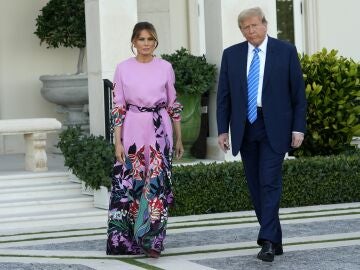 Former President Donald Trump, right, arrives with Melania Trump for a GOP fundraiser, Saturday