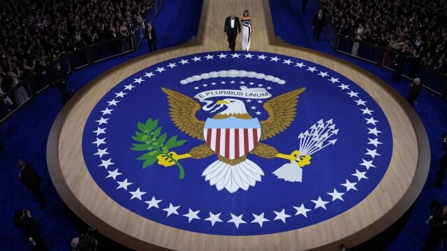 President Donald Trump, left, and first lady Melania Trump walk to the stage to dance at the Commander in Chief Ball, Monday, Jan. 20, 2025, in Washington. 