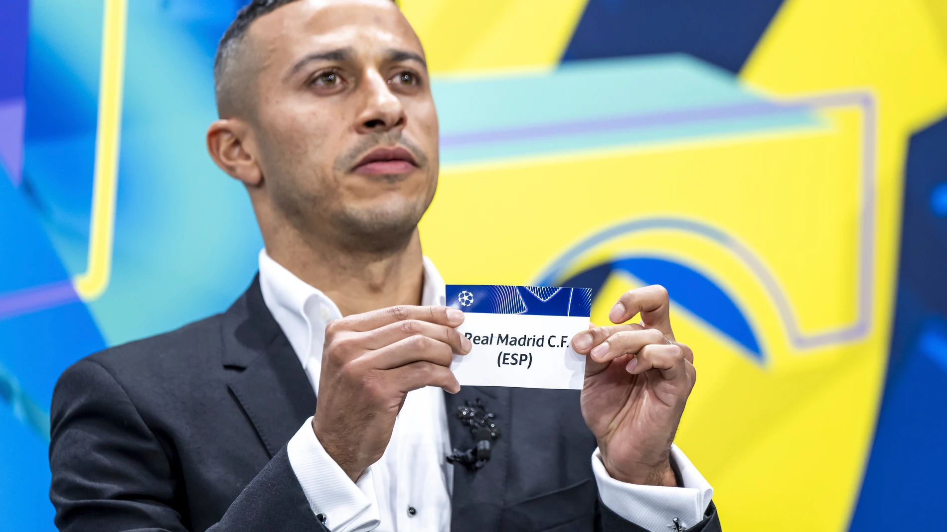 Spain's former player Thiago Alcantara shows a ticket of Real Madrid during the UEFA Champions League knockout phase play-off draw, at the UEFA headquarters in Nyon, Switzerland, Friday, Jan. 31, 2025. (Martial Trezzini/Keystone via AP)