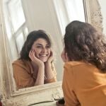 Mujer sonriendo al espejo