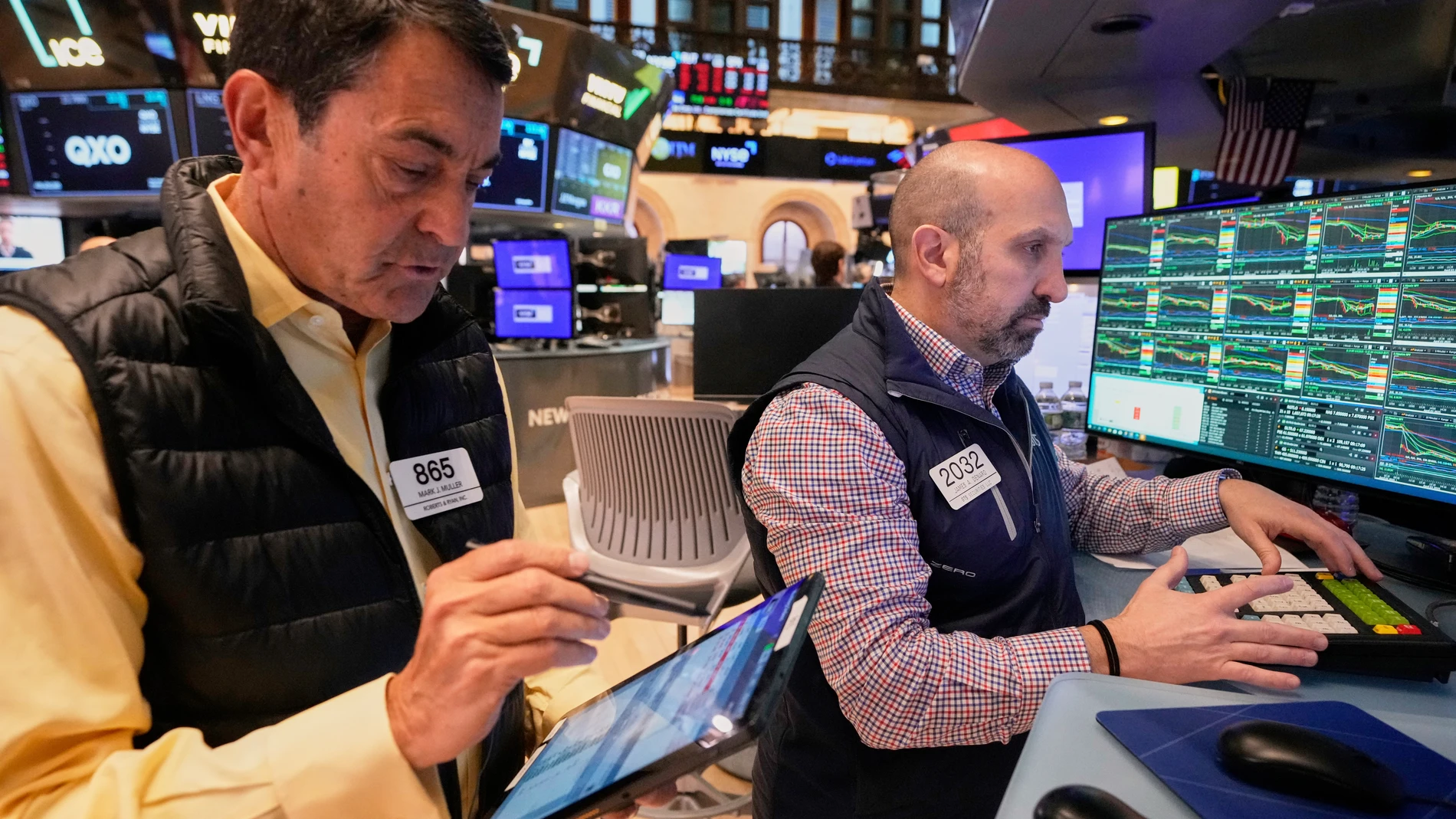 Trader Mark Muller and Specialist James Denaro work on the floor of the New York Stock Exchange, Friday, April 4, 2025. (AP Photo/Richard Drew)