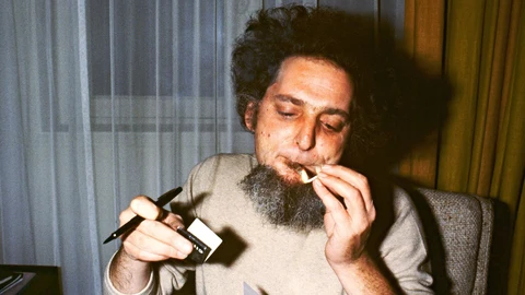 Between two dedications of his book "La Vie Mode D'Emploi" for which he has just received the Medicis Prize, the French writer Georges Perec lights his cigarette (Photo by Michel CLEMENT / AFP)