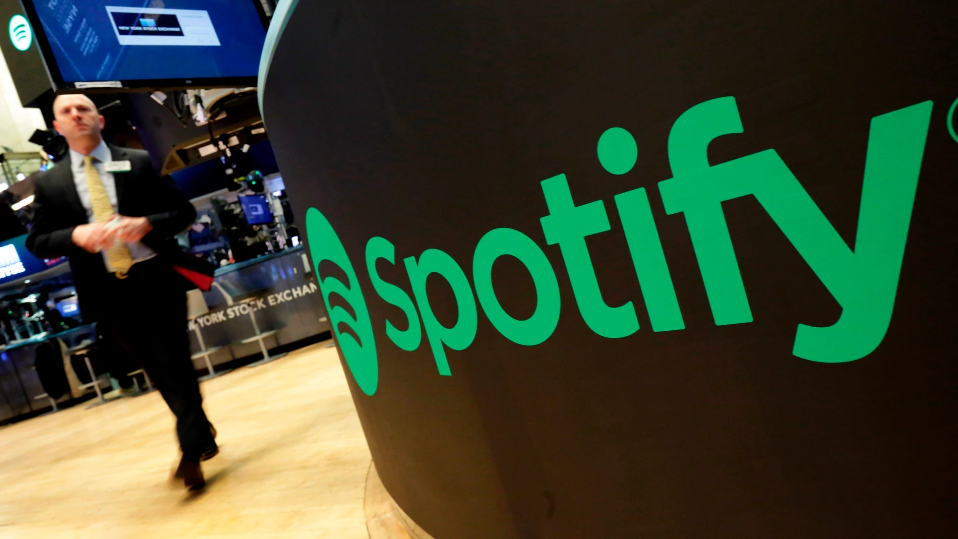 FILE - A trading post sports the Spotify logo on the floor of the New York Stock Exchange, Tuesday, April 3, 2018. (AP Photo/Richard Drew, File)