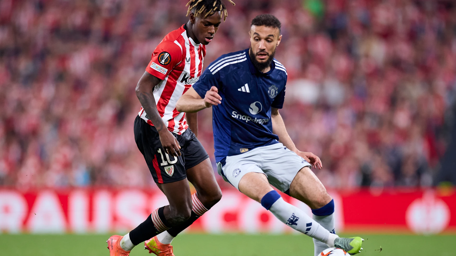 Nico Williams of Athletic Club competes for the ball with Noussair Mazraoui of Manchester United during the UEFA Europa League 2024/25 Semi Final First Leg match between Athletic Club and Manchester United at San Mames on May 1, 2025, in Bilbao, Spain.AFP7 01/05/2025 ONLY FOR USE IN SPAIN