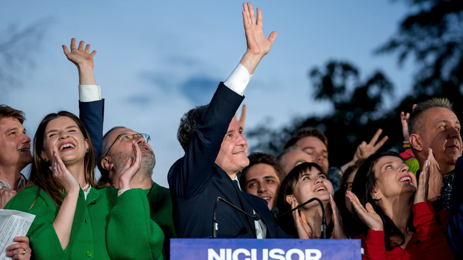 Presidential candidate Nicusor Dan, center, waves to supporters after polls closed for the second round of the country's presidential election redo in Bucharest, Romania, Sunday, May 18, 2025. (AP Photo/Andreea Alexandru)