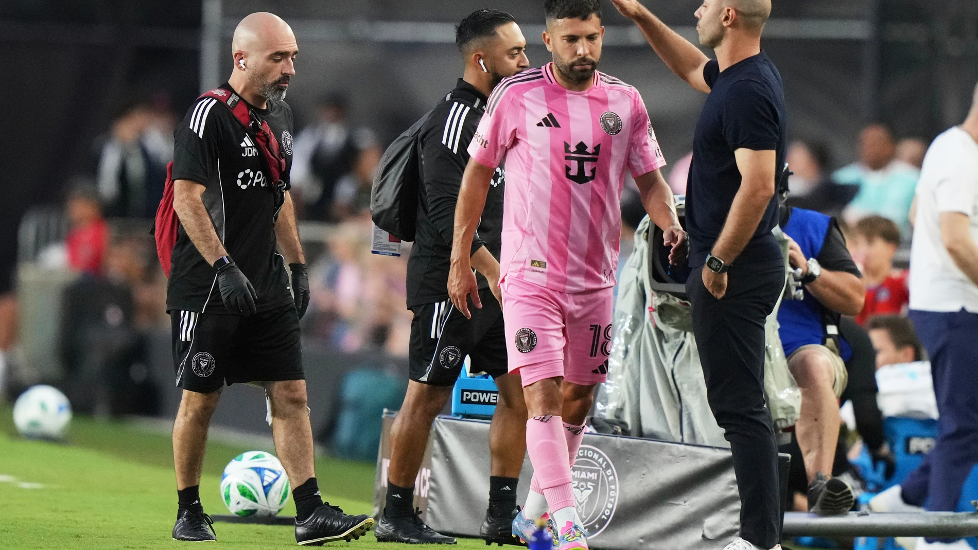Inter Miami midfielder Jordi Alba, second from right, is patted on the head by head coach Javier Mascherano, right, as he leaves the game with an injury during the first half of an MLS soccer match against CF Montreal, Wednesday, May 28, 2025, in Fort Lauderdale, Fla. (AP Photo/Lynne Sladky)