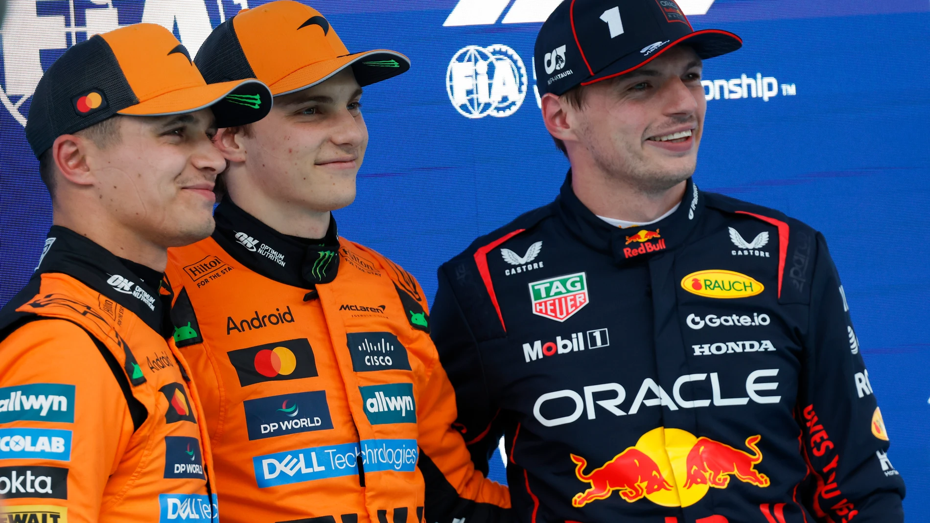 McLaren driver Oscar Piastri of Australia, centre, celebrates his pole position with McLaren driver Lando Norris of Britain, left, and Red Bull driver Max Verstappen of the Netherlands after the qualifying session ahead of the Spanish Grand Prix Formula One race at the Barcelona Catalunya racetrack in Montmelo, near Barcelona, Spain, Saturday, May 31, 2025. (AP Photo/Joan Monfort)