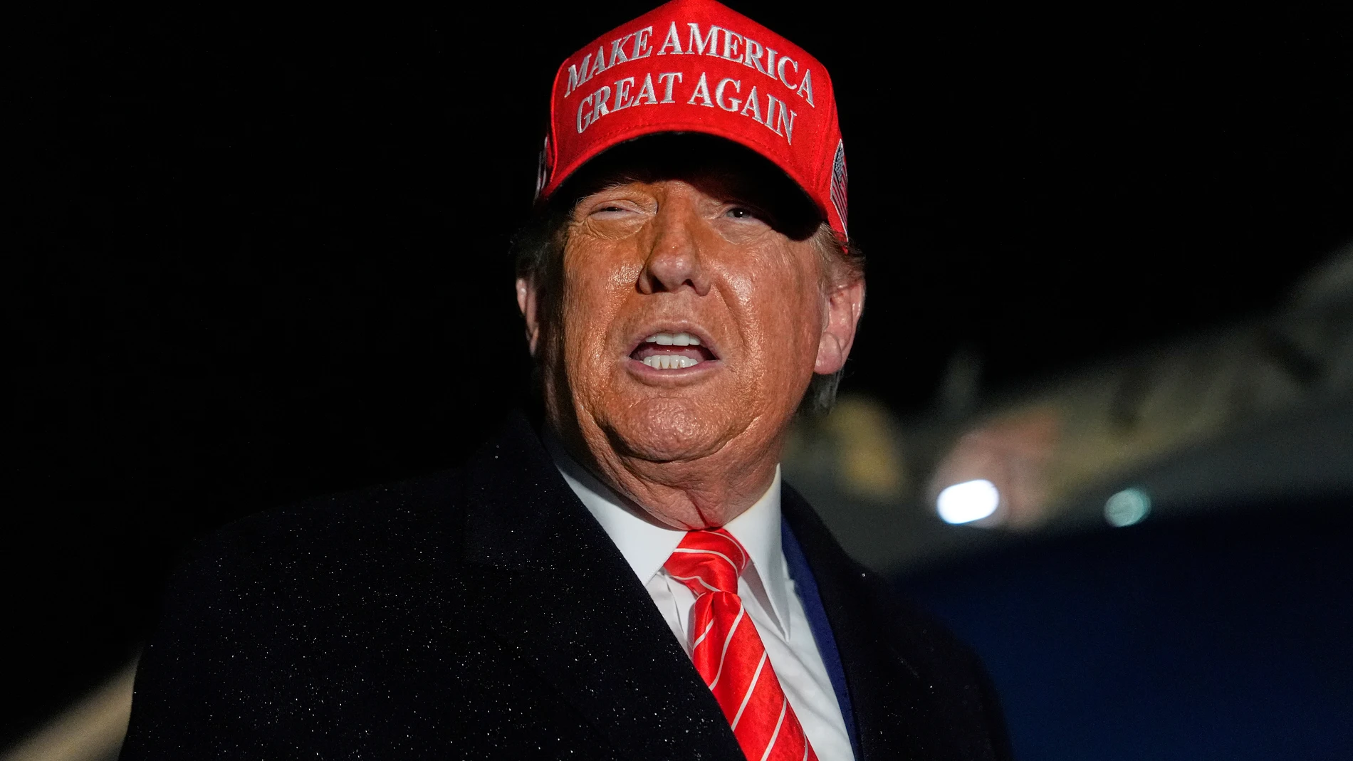 President Donald Trump speaks to reporters in the rain after arriving on Air Force One at Joint Base Andrews, Md., Friday, May 30, 2025. (AP Photo/Julia Demaree Nikhinson)