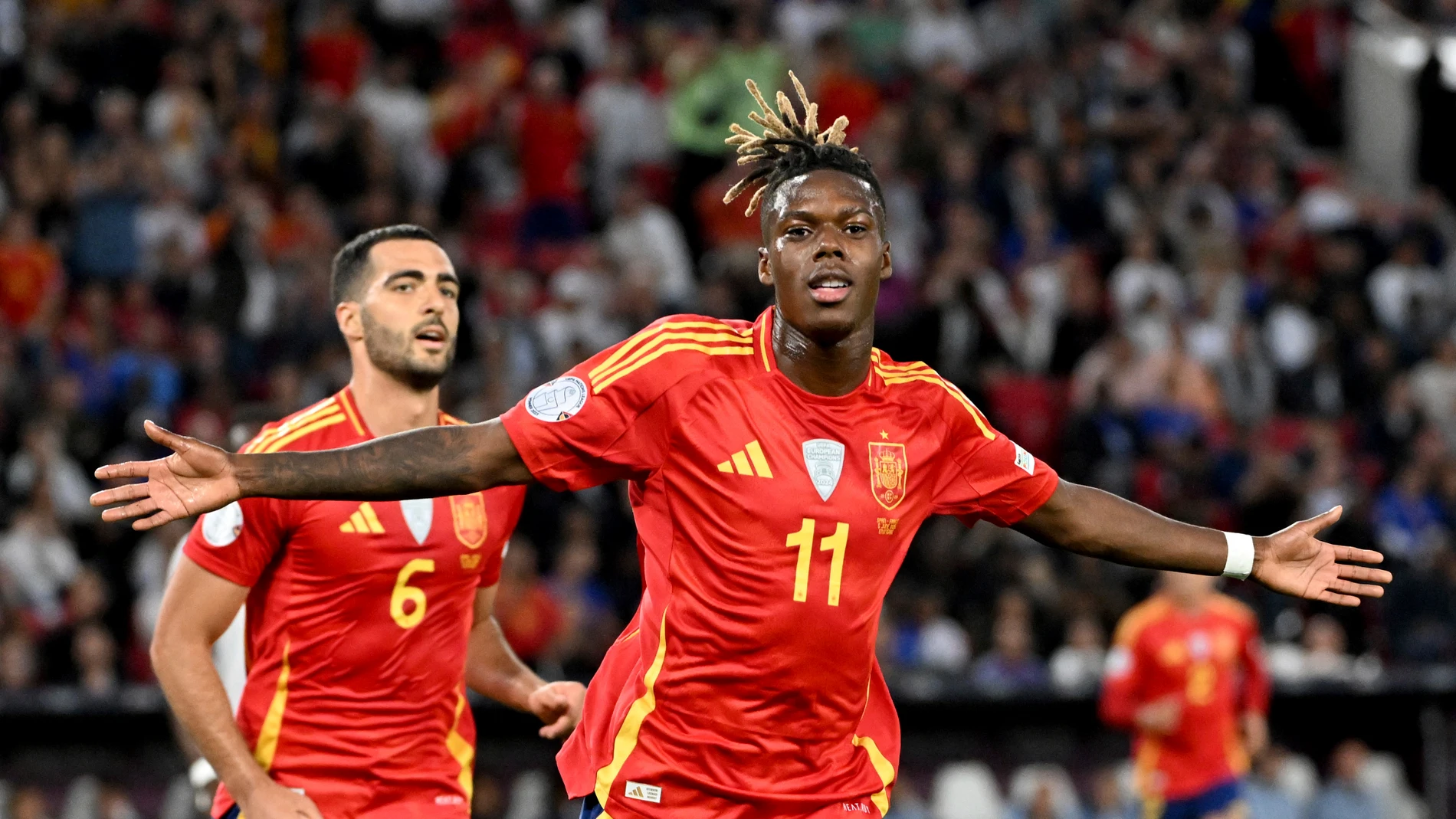 Spain's scorer Nico Williams, right, and and his teammate Mikel Merino, left, celebrate the opening goal during the Nations League semifinal soccer match between Spain and France in Stuttgart, Germany, Thursday, June 5, 2025. (Marijan Murat/dpa via AP)