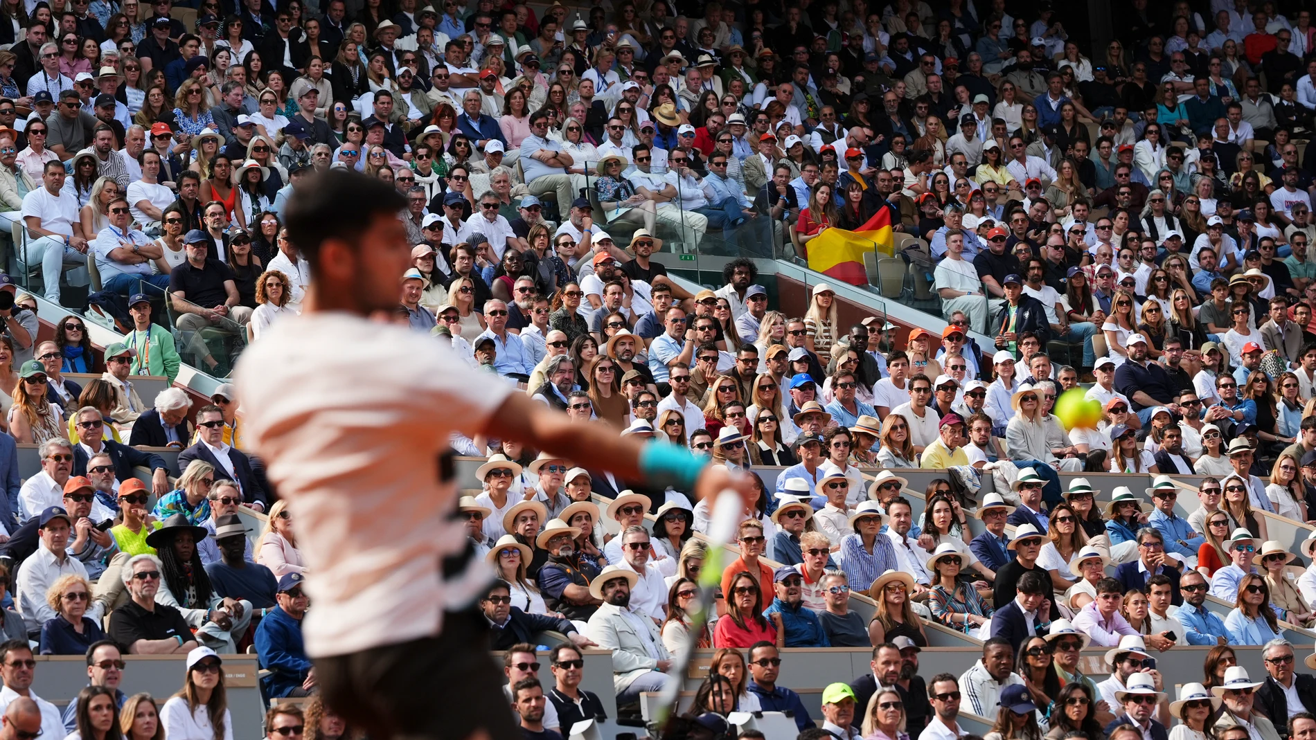 Spectators watch as Spain's Carlos Alcaraz plays a shot against Italy's Jannik Sinner during their final match of the French Tennis Open at the Roland-Garros stadium in Paris, Sunday, June 8, 2025. (AP Photo/Lindsey Wasson)