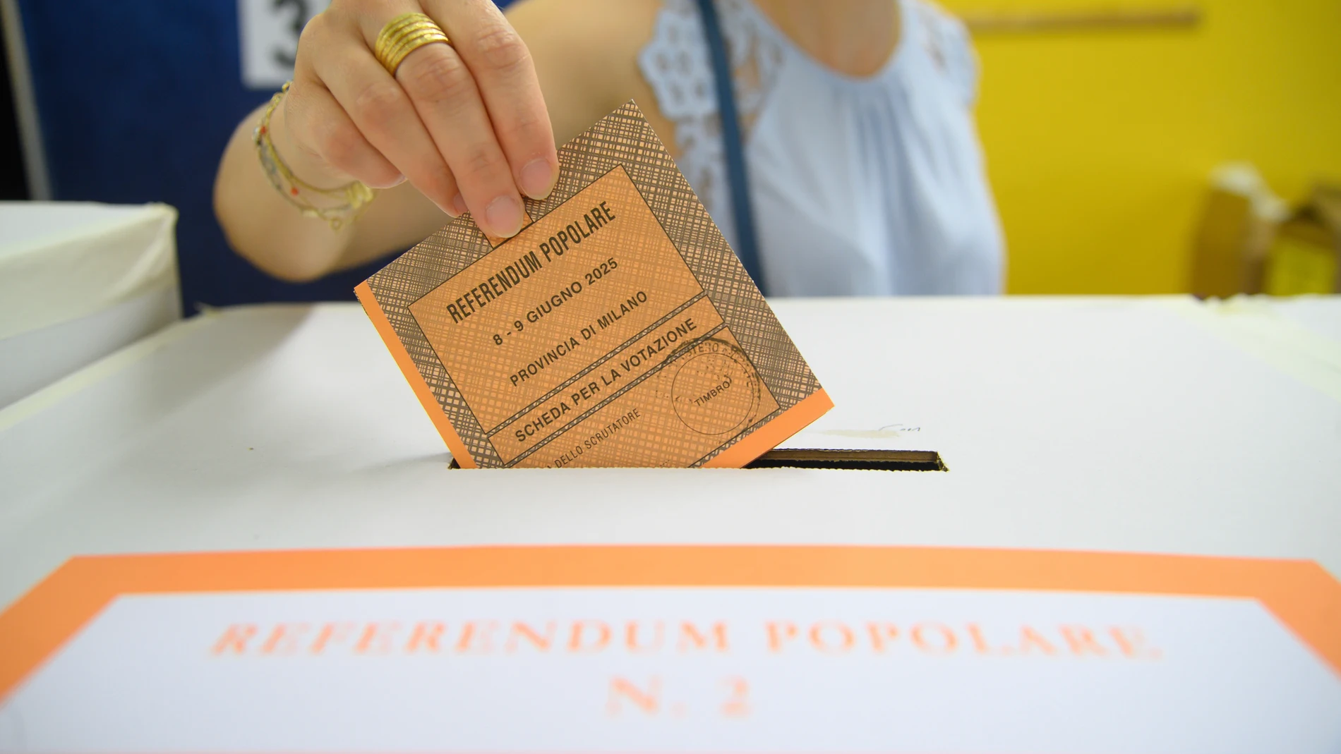 A woman casts her ballot in a box for referendums on citizenship and job protections, at a polling station in Milan, Italy, Sunday, June 8, 2025. (Claudio Furlan/LaPresse via AP)