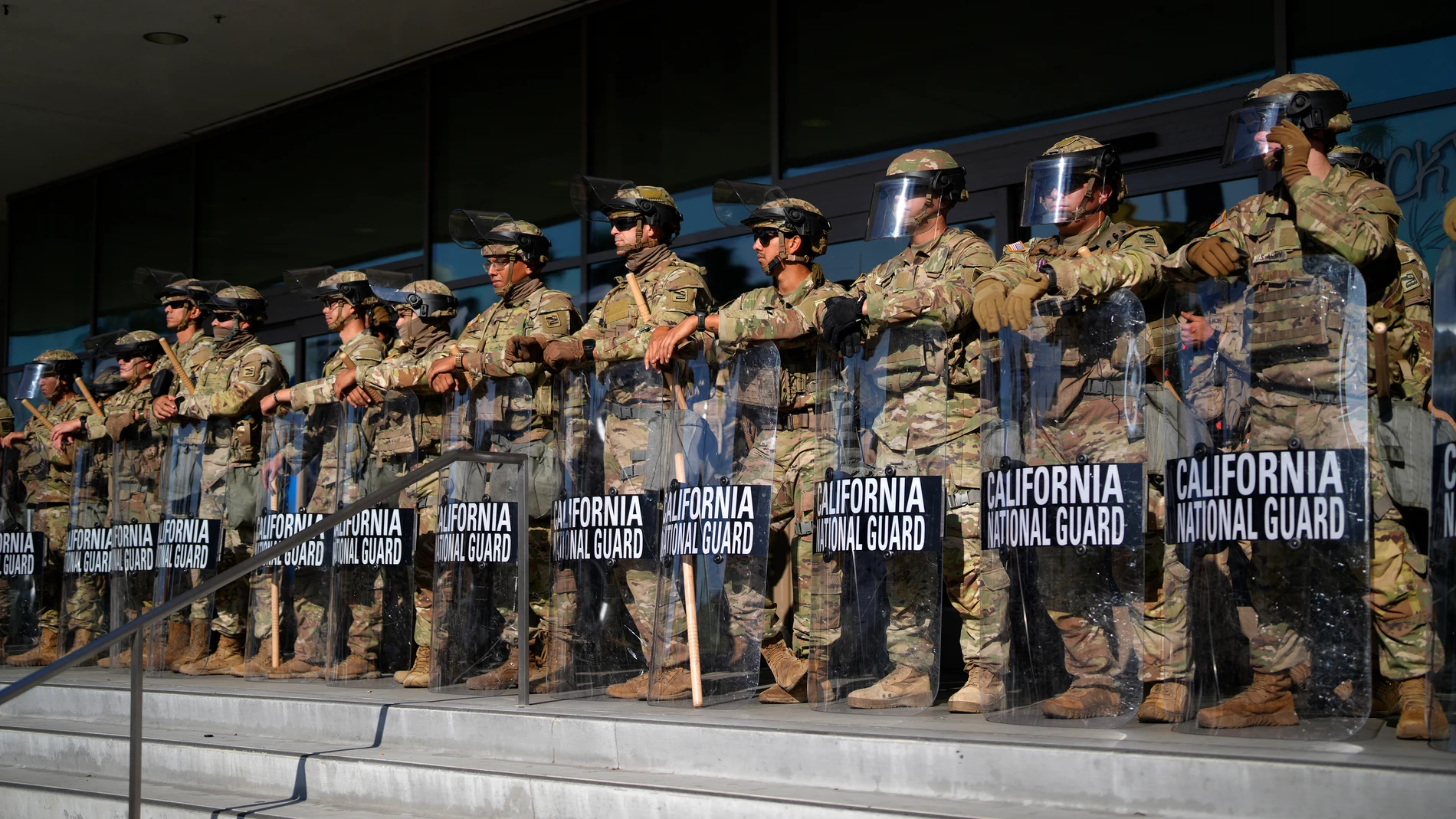 California National Guard stand in formation guarding the federal building in downtown Los Angeles on Tuesday, June 10, 2025. (AP Photo/Eric Thayer)